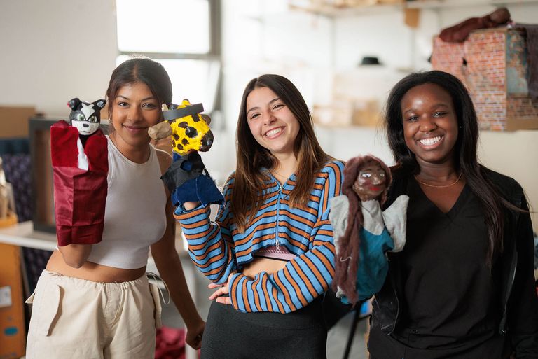 BU students holding the puppets they created for a video showcasing the research of the BU Motor Development Lab