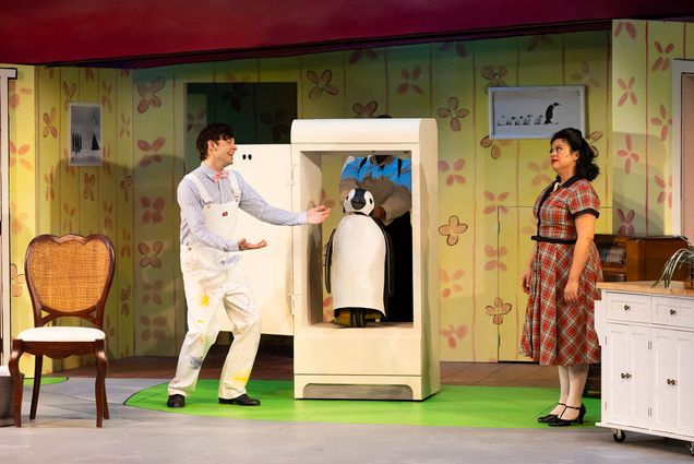 Michael Jennings Mahoney (far left standing with a smile on his face) and Kristian Espiritu (far right standing with a stern look on her face) star as Mr. and Mrs. Popper in Wheelock Family Theatre’s production of Mr. Popper’s Penguins, based on the novel by Richard and Florence Atwater.