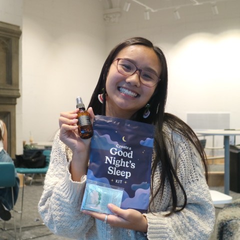 Boston University College of Fine Art student holding the pillow mist they made while attending CFA's Stress Reliever event focused on Healthy Sleeping.