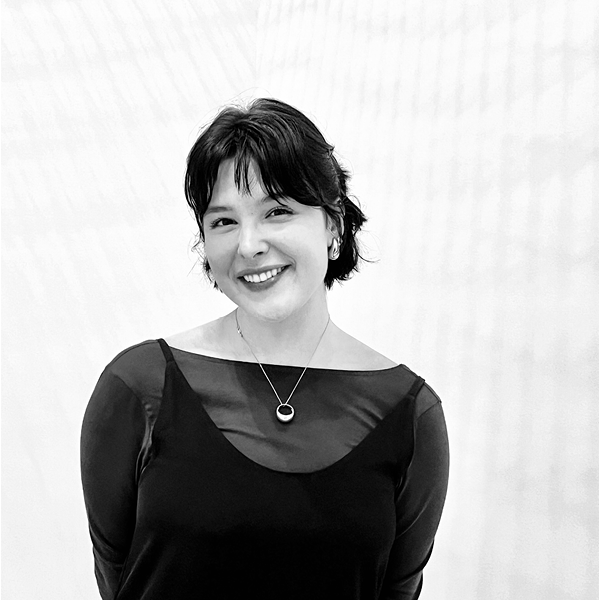 Jayna Mikolaitis, black and white photo, smiling in long-sleeve dress