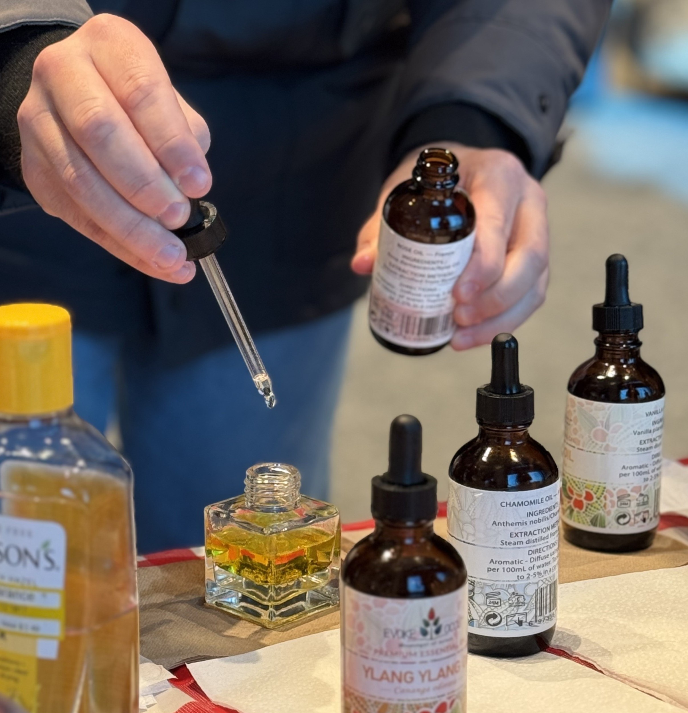 A Boston University College of Fine Art student adds essential oils to their custom reed diffuser at CFA's Stress Reliever event.