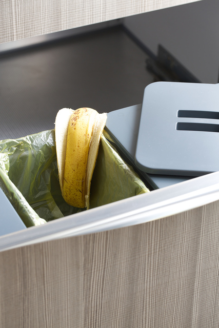 Three mounted trash bins.