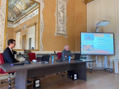 two individuals sitting in a conference hall