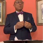 picture of a man in formal attire speaking in public