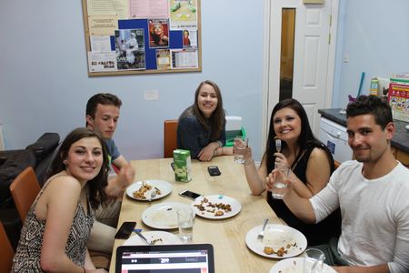Students make a home-cooked meal back at the residence and enjoy it together. Photo by Ross Hurlock