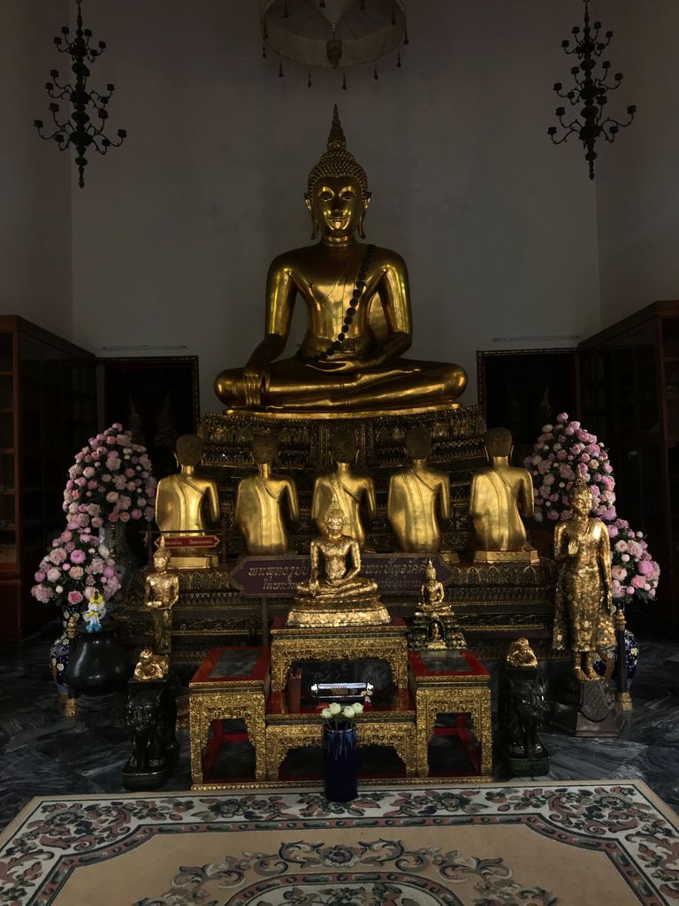 A picture of a golden altar surrounded by flowers