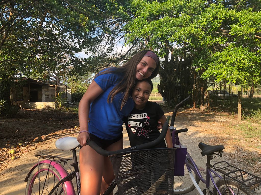 Hallie Nothmann hugging a younger girl