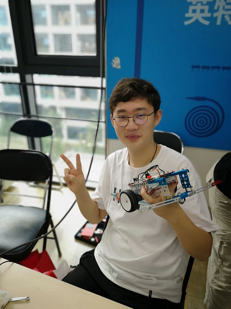 Ruofan Shi holding a robot car