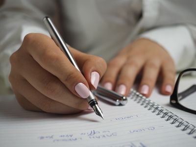 woman writing on a notebook