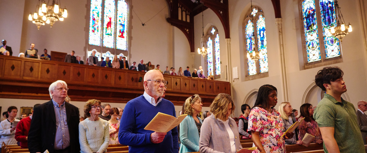 Members of the congregation standing for a hymn at a worship service in the Marsh sanctuary