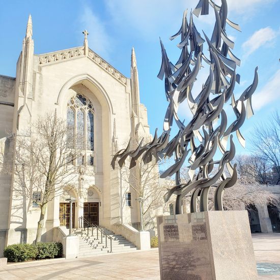 outside shot of the front of the chapel with clear blue skies, MLK "Free at Last"statue in foreground