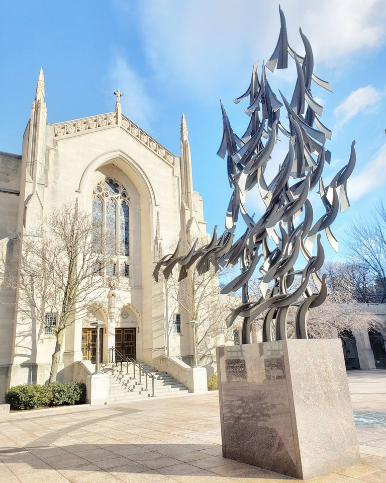 outside shot of the front of the chapel with clear blue skies, MLK "Free at Last"statue in foreground
