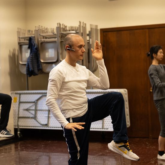 Image of instructor and students performing a taichi pose in the chapel
