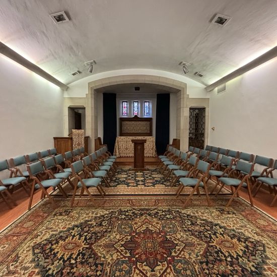 Interior of Robinson Chapel set up with chairs in rows and a pulpit in the center of the stage area