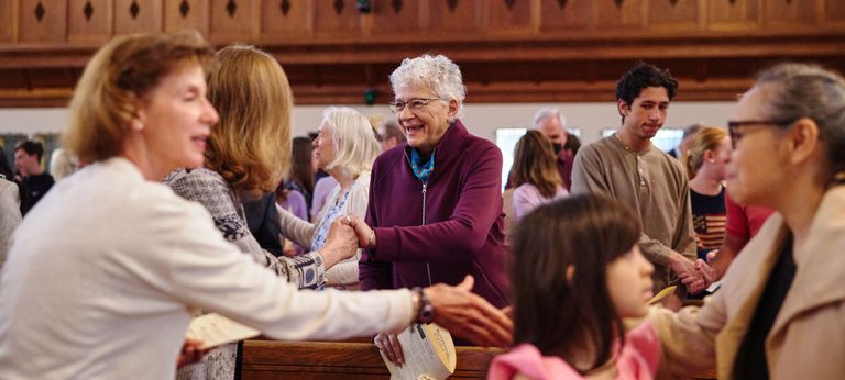 Members of the Marsh Congregation shake hands and share smiles and greetings during the Easter worship service.