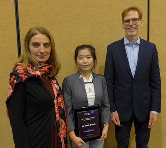 Translational Research Symposium co-chiars Gabriela Apiou (far left) and Bruce Tromberg (far right) present the Translational Research Best Paper Award to Boston University's Pu-Ting Dong (center)
