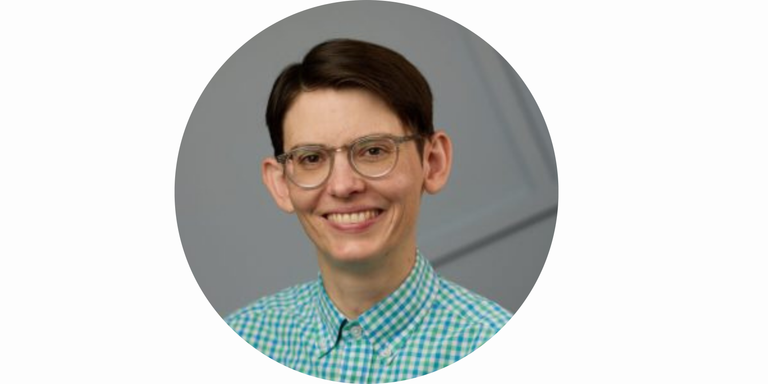 Allison Reilly's headshot. Photo of a smiling person from their shoulders up. They have short brown hair, clear-rimmed glasses, peach/white skin and are wearing a green and blue checkered shirt. The background behind them is gray with intersecting lines.