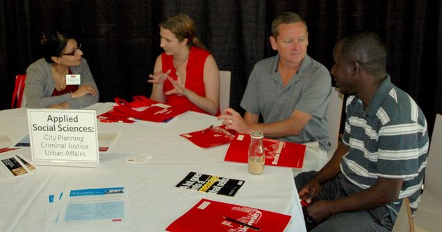 Prof. Dutta-Koehler (L) and James Belmore (M) discuss Program benefits at the MET Open House