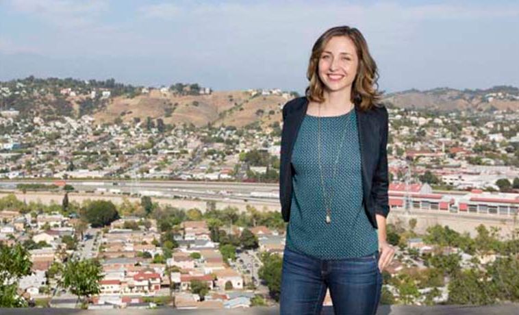 Corrine Brinkerhoff posing with Los Angeles in the background.