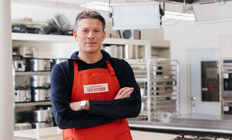 David Nussbaum posing with arms crossed in an America's Test Kitchen apron.