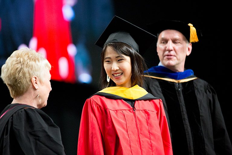 Student smiling on stage