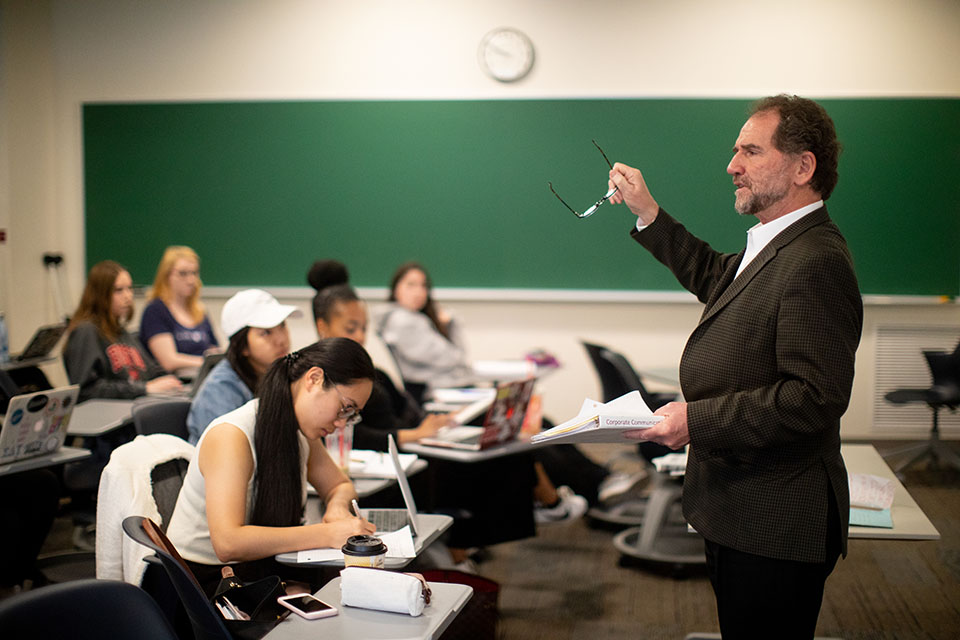 Prof. Stephen Quigley gestures during a lecture.
