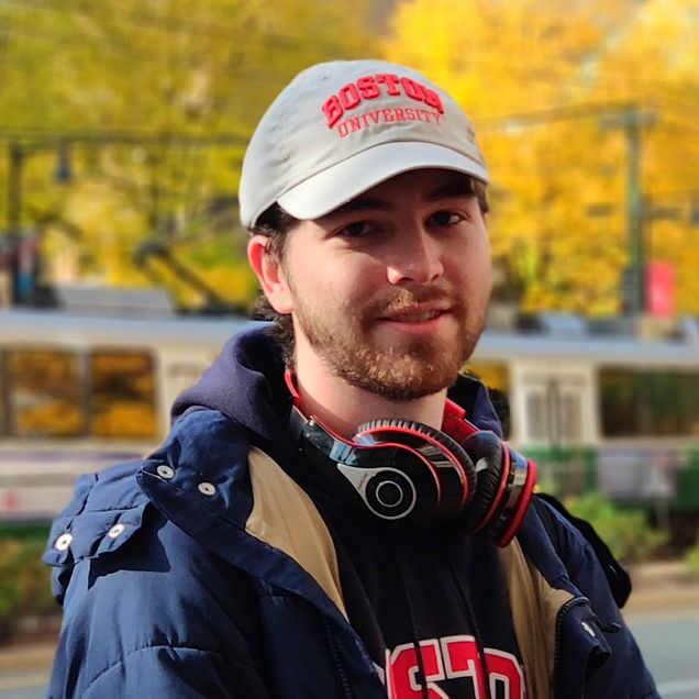 Eric Hansen wearing a baseball cap and smiling.