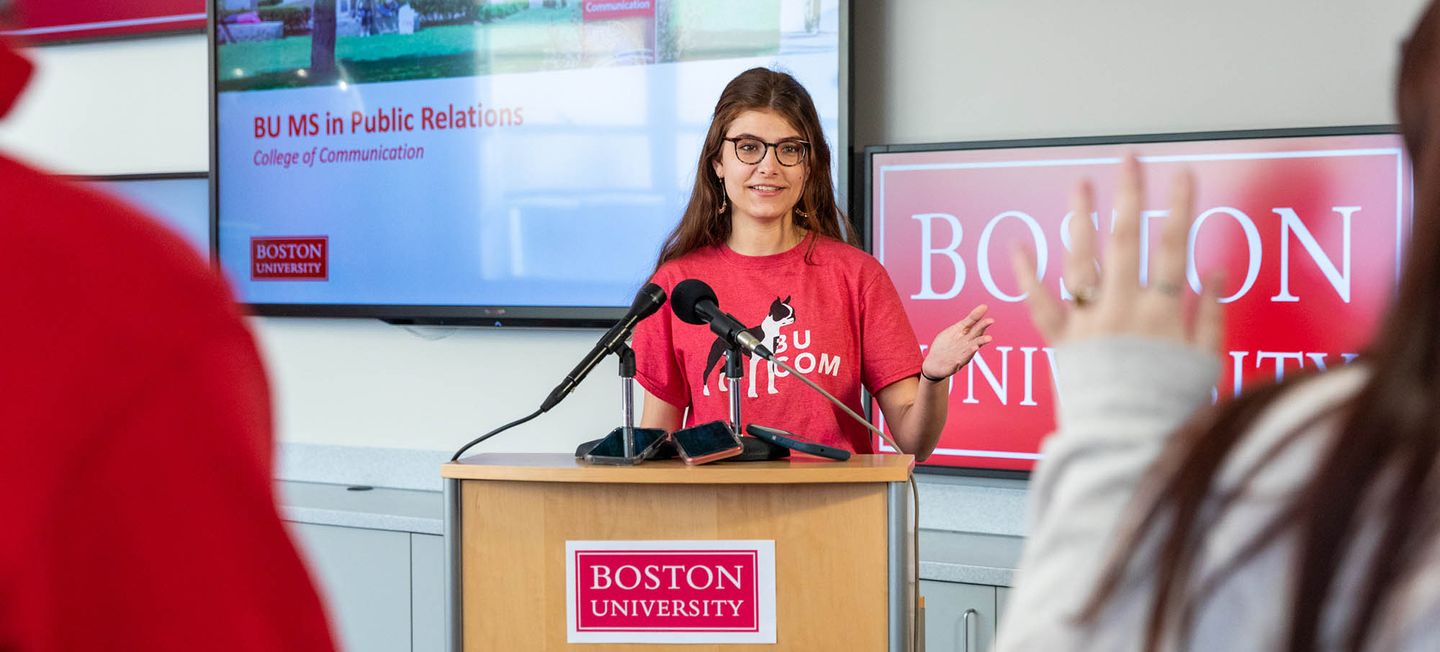Woman giving address from lectern.
