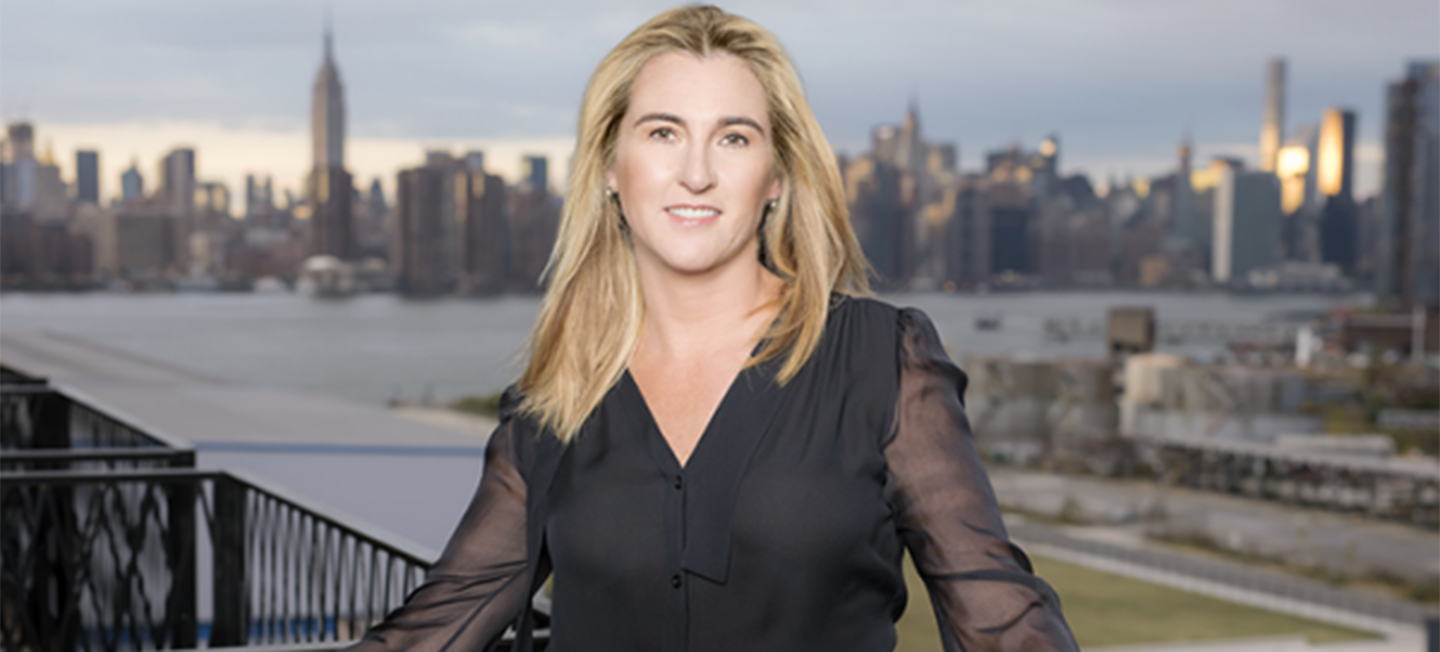 Nancy Dubuc portrait with New York City skyline in background.