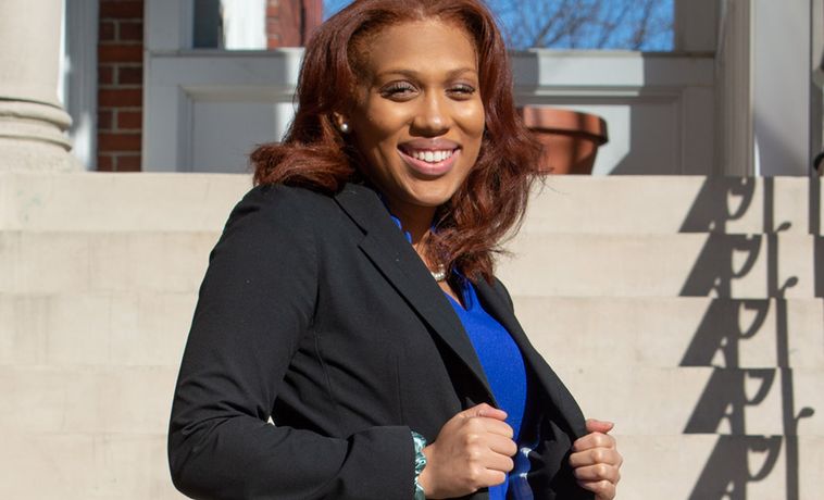 Nyah Jordan smiling portrait in front of staircase outdoors.
