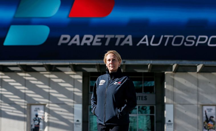 Beth Paretta portrait standing outside offices of Paretta Autosport