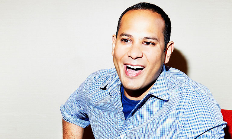 Sopan Deb laughing while seated in a chair.