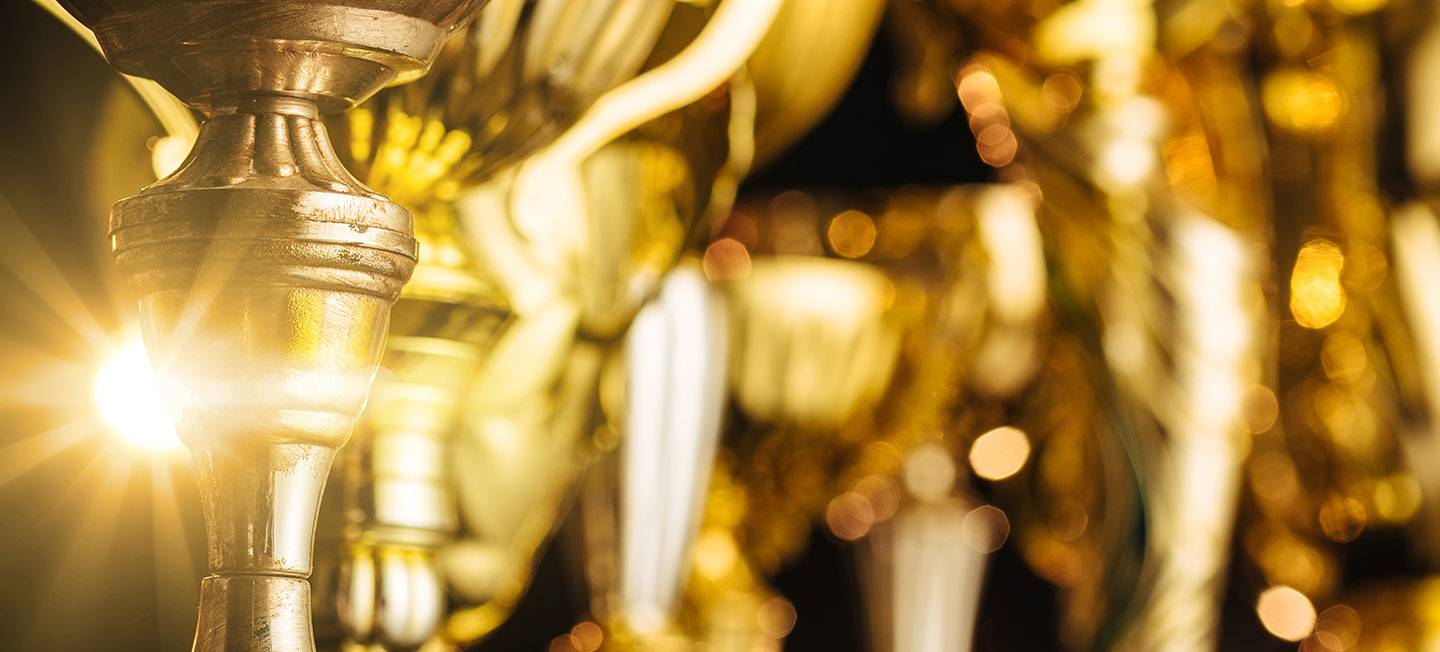 Group of the golden trophies in sparkling light.