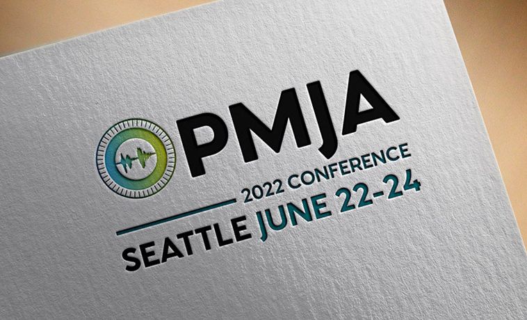 PMJA logo embossed on card with conference location (Seattle) and date (June 22-24, 2022).