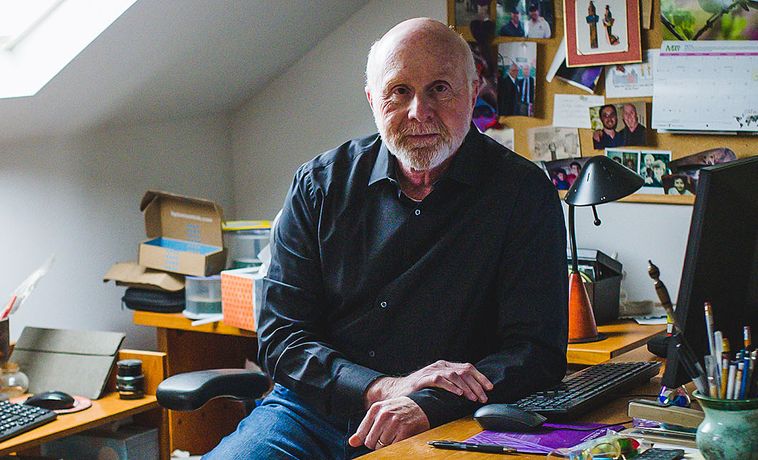Writer Glenn Rifkin seated at his home office desk.