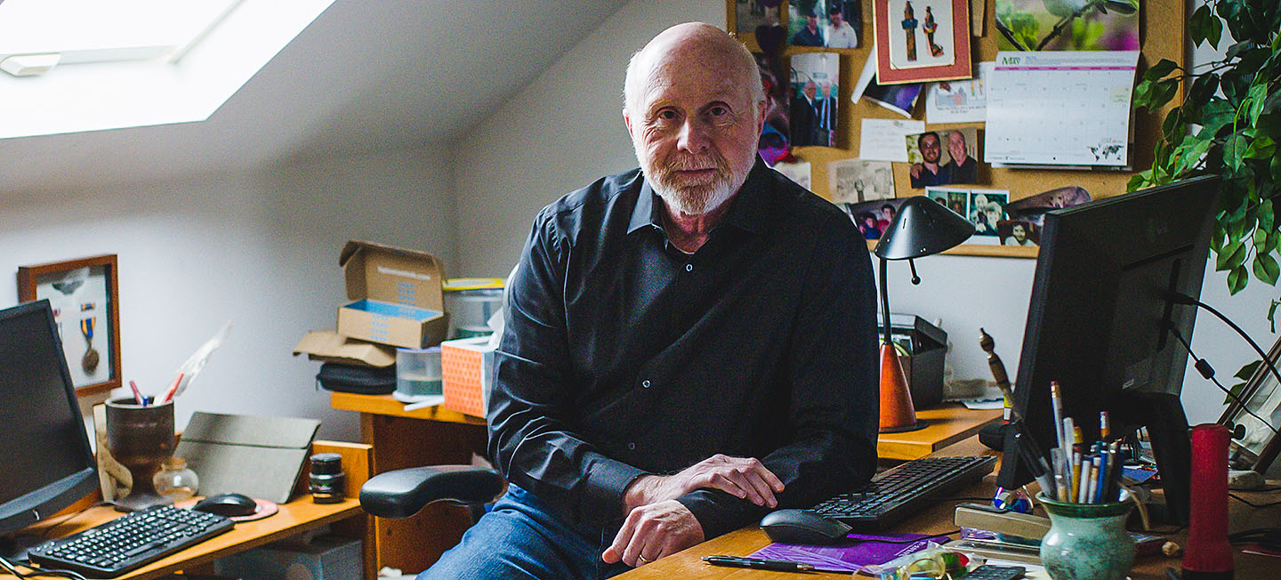 Writer Glenn Rifkin seated at his home office desk.