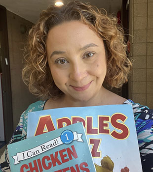 Leslie Gang poses with two children's books.