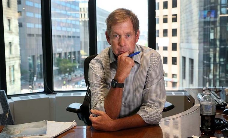 Brian McGrory seated at his desk at the Boston Globe.
