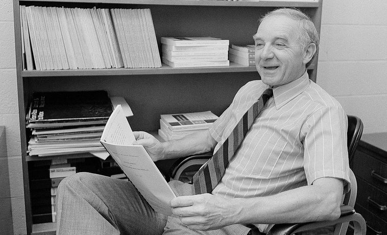 Otto Lerbinger seated in his office.