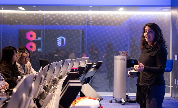 Amy Shanler speaks in front of a group of students during a visit to IBM.
