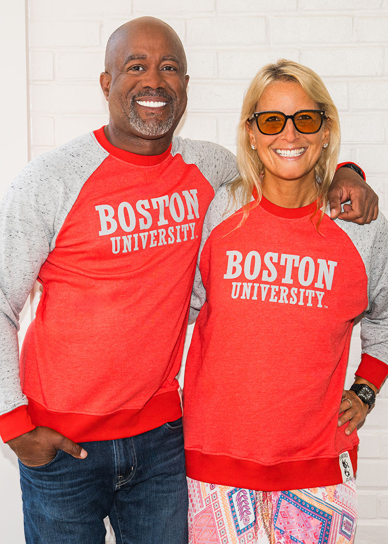 Darius Rucker poses with Bettie Levy. Both are wearing t-shirts that read 'Boston University.'