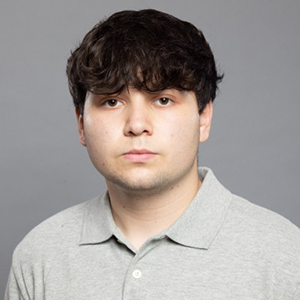Serious headshot with gray backdrop