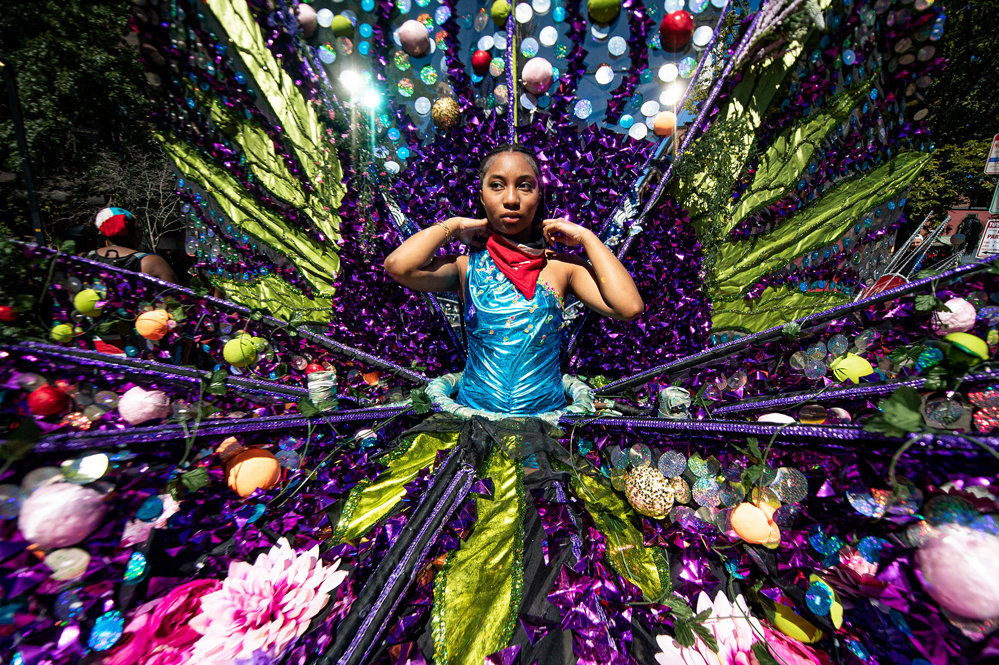 Girl wearing ornate and multicolored dress.