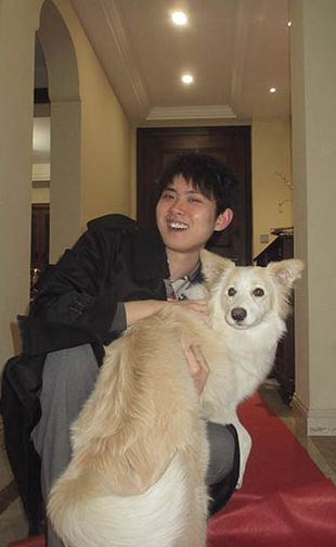 Wenxiang Dai portrait with white and light brown colored dog.
