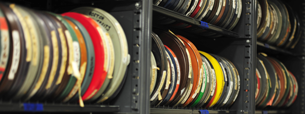 Archived film reels sit on a shelf.