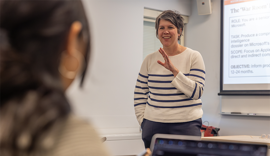 A photo of Christian giving a talk in the classroom. 