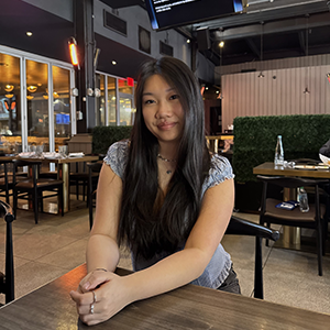 A photo of Alyson Yam sitting at a desk. 