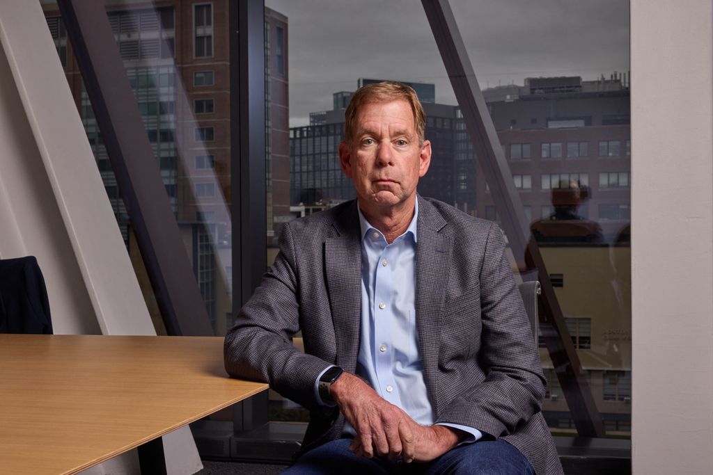 A photo of Brian McGrory, chair of journalism, sitting in front of a desk.