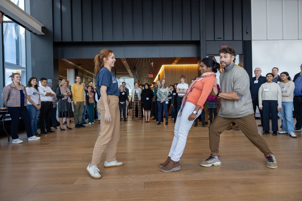 A photo of attendees of MISI’s first summit learning about risk and collaboration from a circus acrobat.