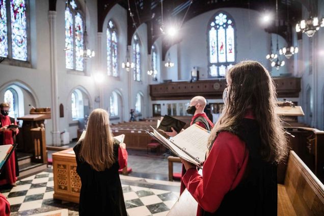 View from behind the Marsh Chapel choir looking out into an otherwise empty Marsh Chapel as they perform during the 2021 Baccalaureate service at Boston University's 148th Commencement. The choir was separated from the location of the main service and broadcast by video as a social distancing measure.